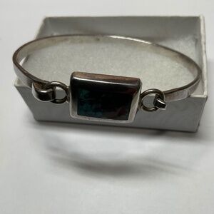 Sterling Silver Hinged Bracelet with Turquoise Chips. 2 3/8 inches across